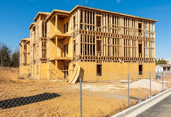 a close-up of temporary chain link fences enclosing a construction site, signaling progress in the project's development in Ludlow MA